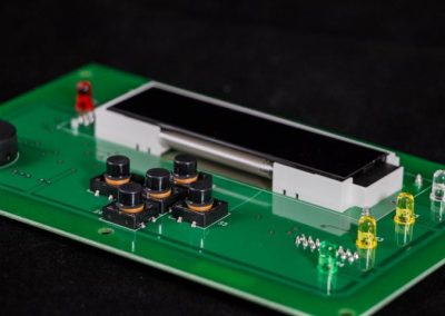 A Single PCBA Assembled by a PCB Board Manufacturer Displayed on Top of a Black Background